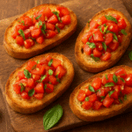 Bruschetta Italiana Tradicional, o antipasto clássico com pão rústico tostado, tomate fresco, manjericão e azeite de oliva.